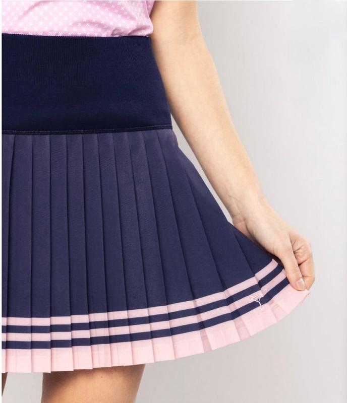 Navy pleated skirt with pink trim on a plain background